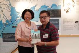 Ms. Leonie Ki presents the new book to the attended fishermen interviewees.