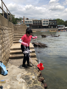 Katie Yeung collects a seawater sample from Sai Kung