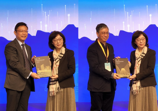 Professor Wei Pan and Ir K.L. Tam receive the Outstanding People (MiC Advocator) from Ms Bernadette Linn, Secretary for Development, HKSAR